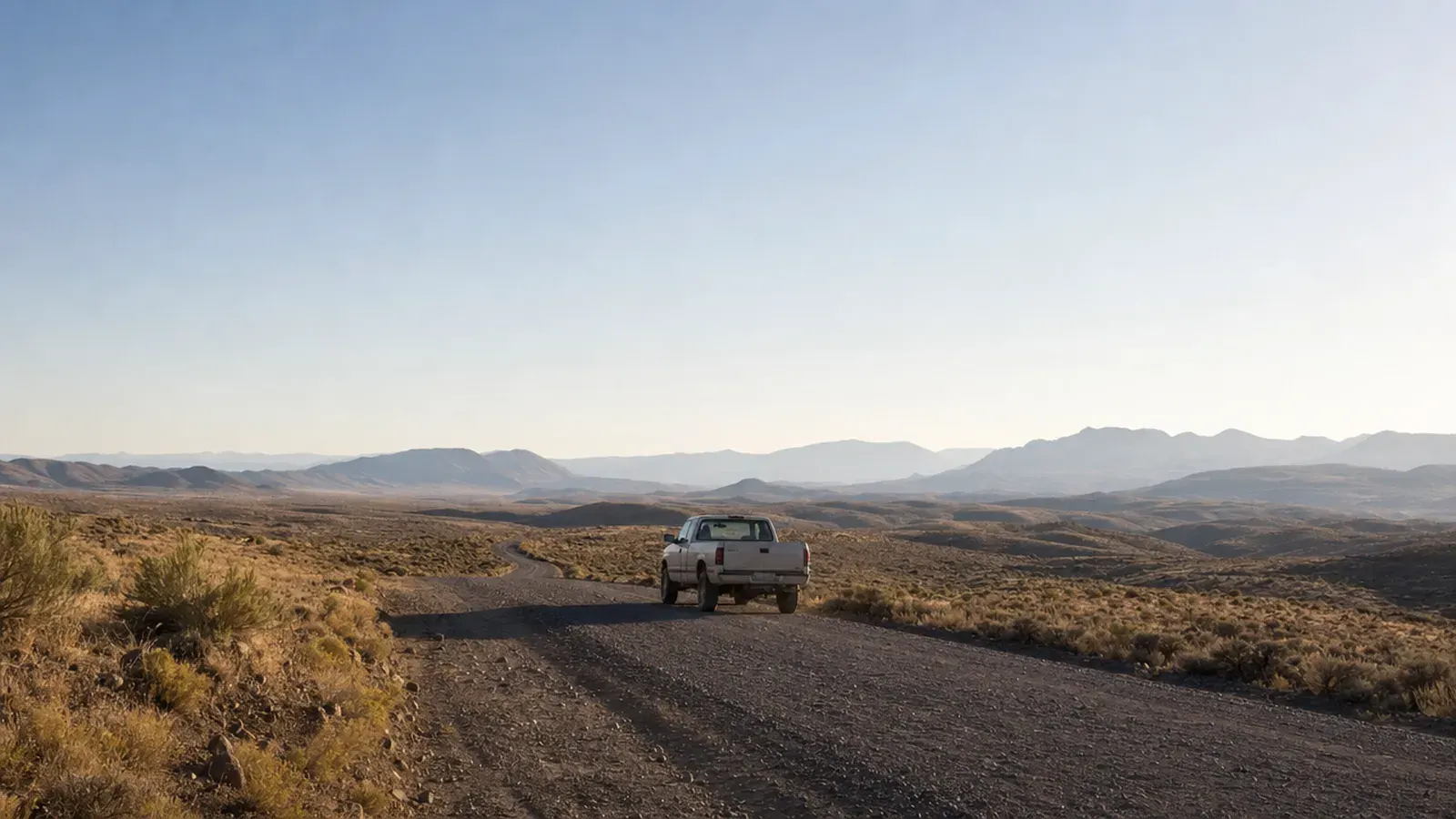A work pickup on a gravel road, far from signal