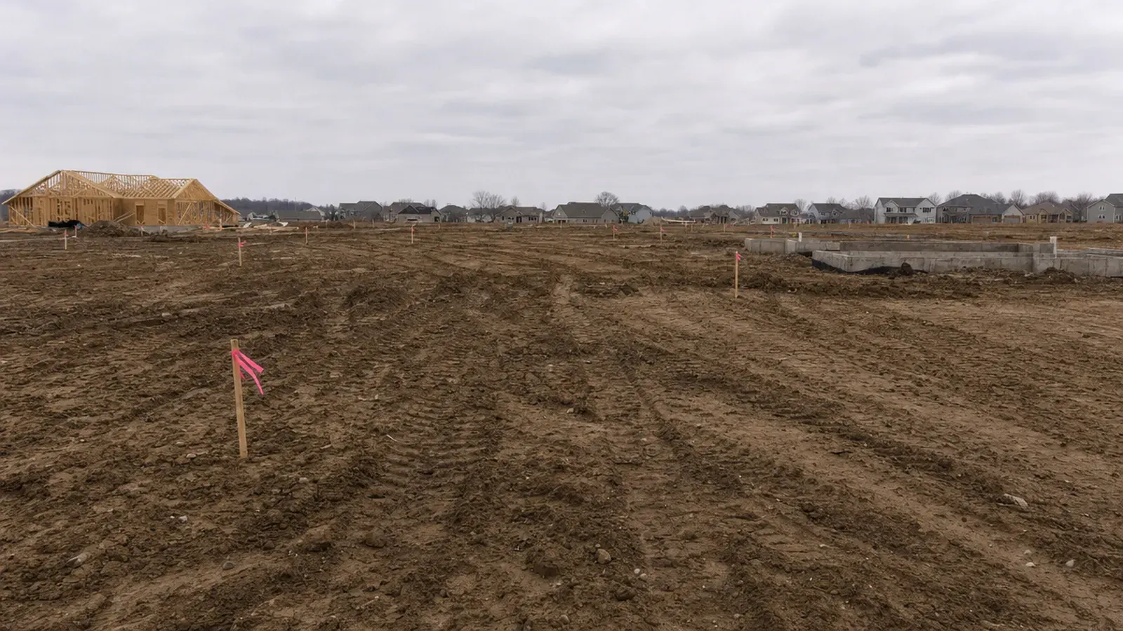 A new subdivision in graded dirt, lot corners flagged